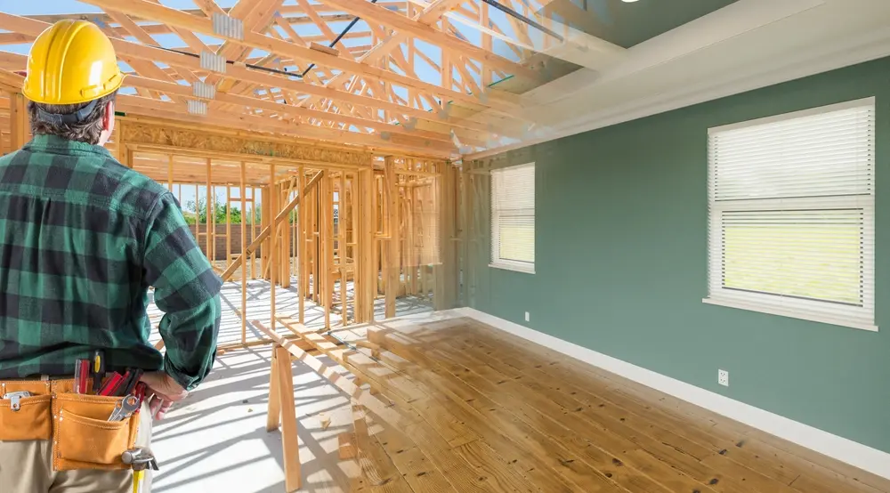 Contractor Facing Before and After Interior of House Wood Construction Framing and Finished Build.