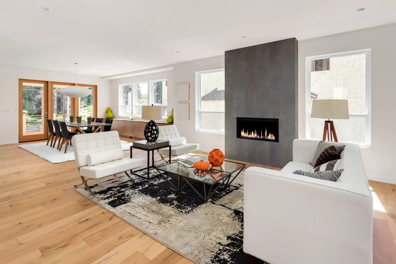 Modern remodeled living room with fireplace and open floor plan renovation